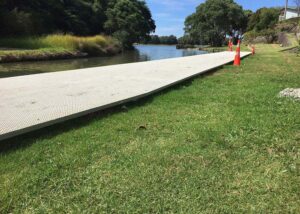 FRP mini mesh grating installed as a walkway by the water in a public reserve.