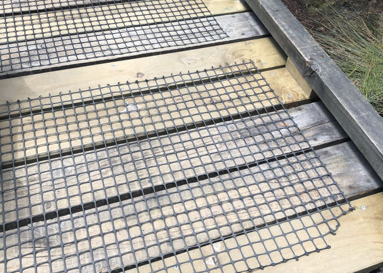 Mesh netting on timber walkway.