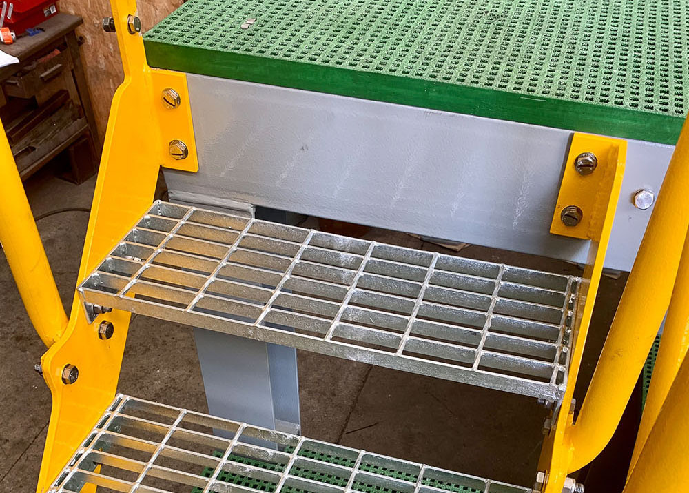 Steel grating stair platform in industrial factory.
