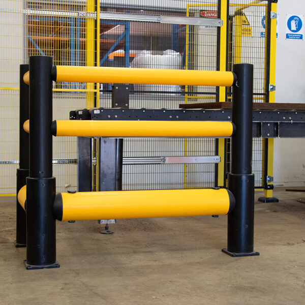 Flexible yellow bollards in workshop.