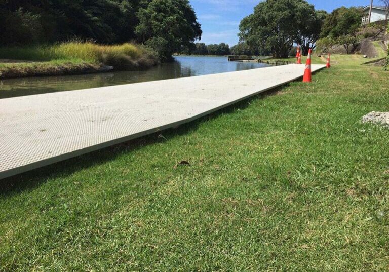 FRP mini mesh grating installed as a walkway by the water in a public reserve.