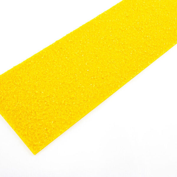 A rectangular strip of bright yellow textured material lies on a white surface.