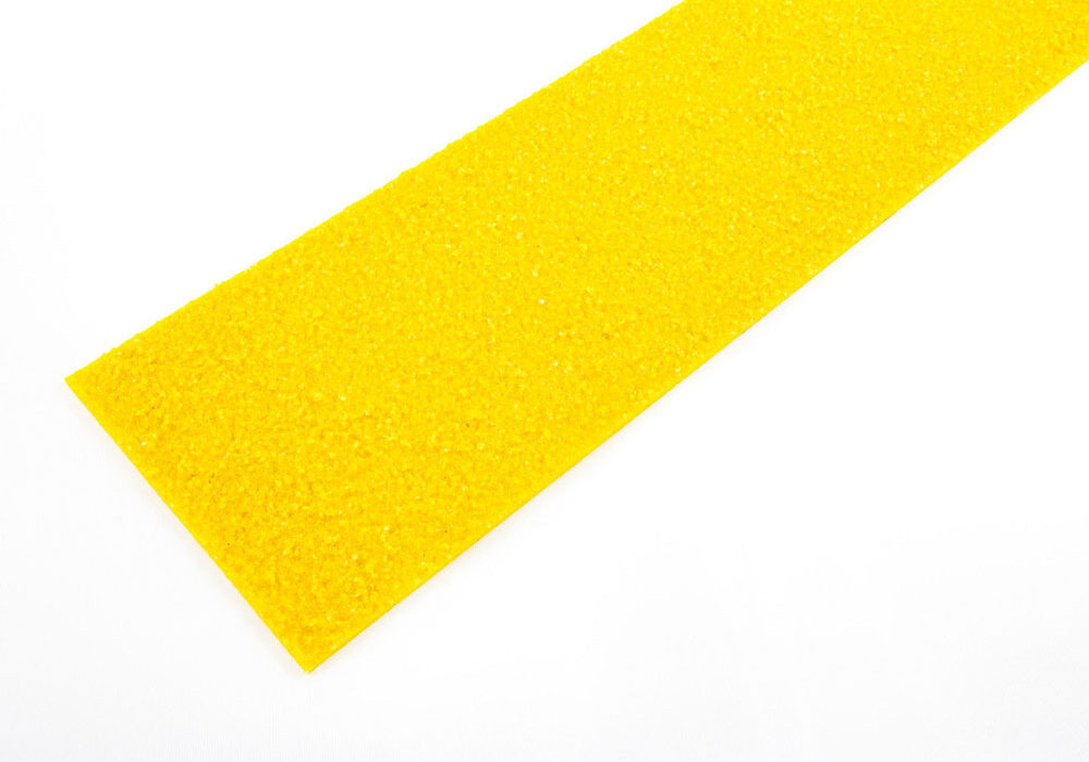 A rectangular strip of bright yellow textured material lies on a white surface.