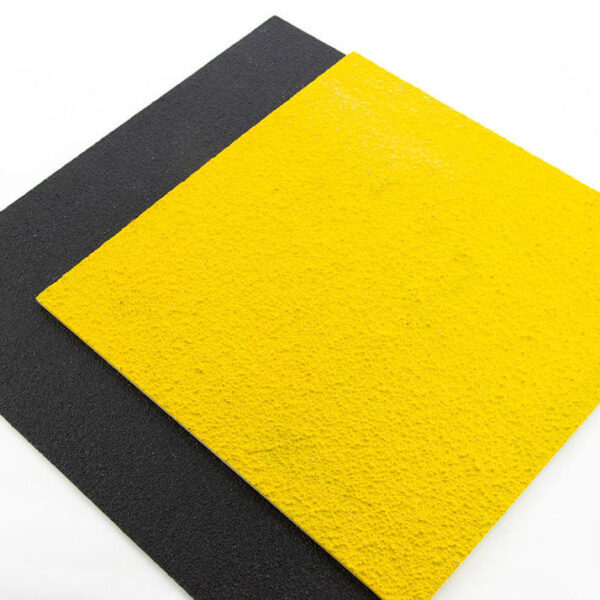 Two sample pieces of FRP Anti-Slip Flat Sheets stacked on each other, one yellow and one black.