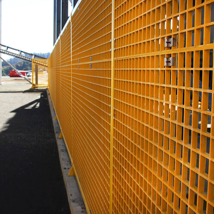 FRP yellow modular guarding around conveying system in factory.