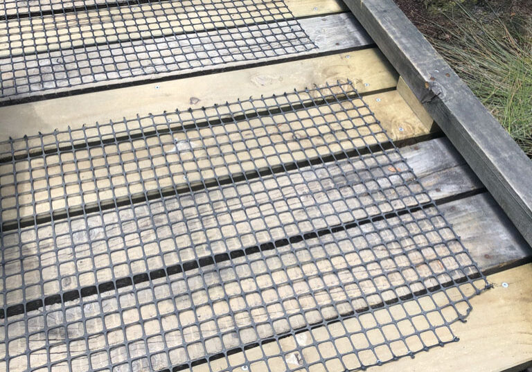 Mesh netting on timber walkway.