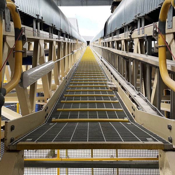 Steel grating ramp cleats in industrial factory.