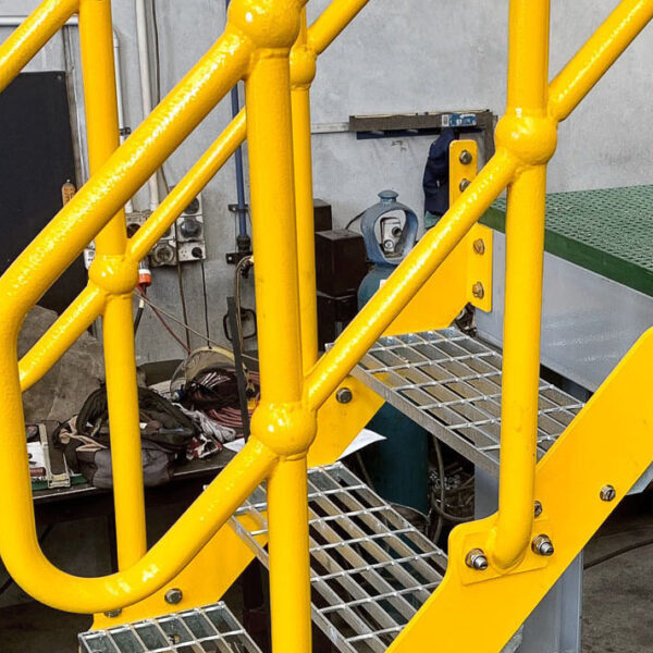 Steel yellow handrail platform in an industrial building.