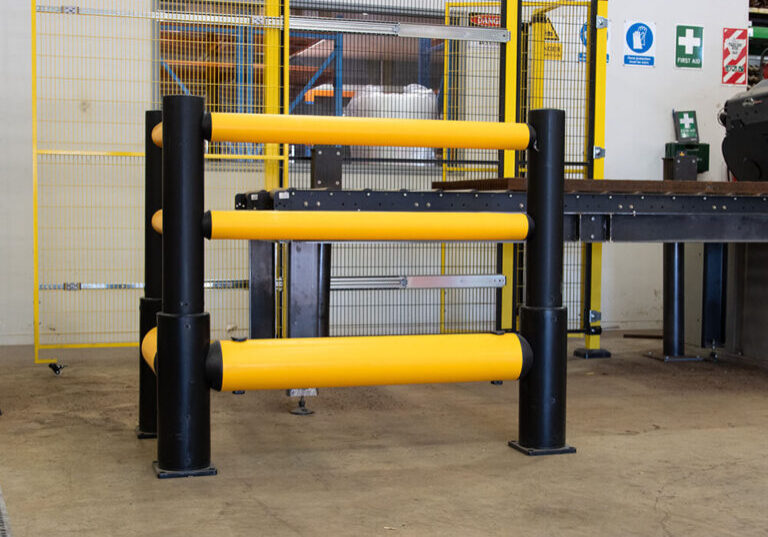 Flexible yellow bollards in workshop.