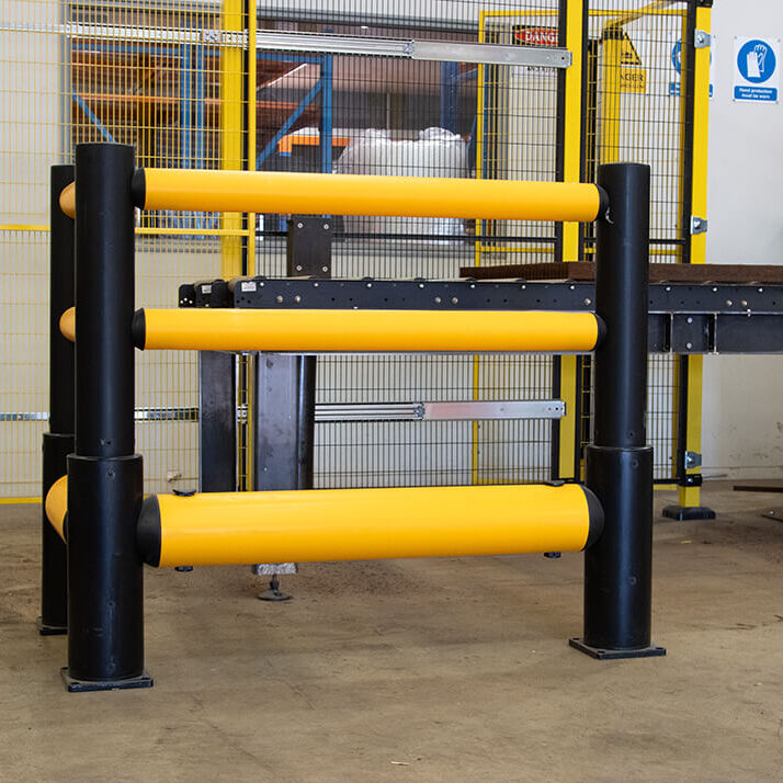 Flexible yellow bollards in workshop.