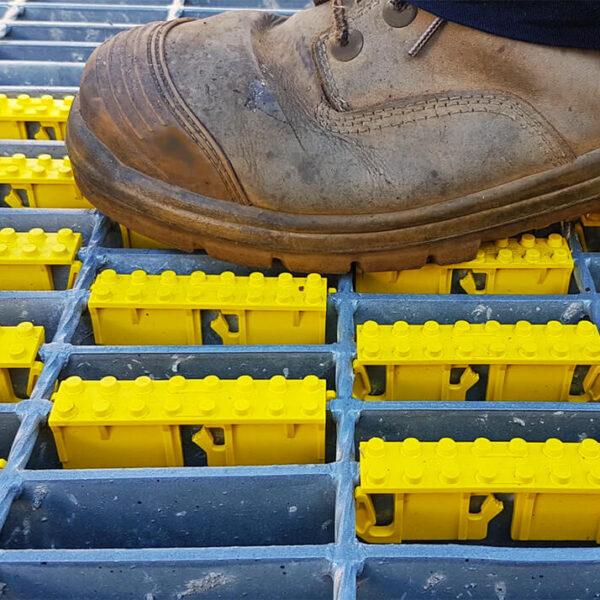 Yellow grate cleats on steel grating.