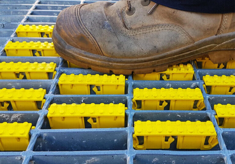 Yellow grate cleats on steel grating.
